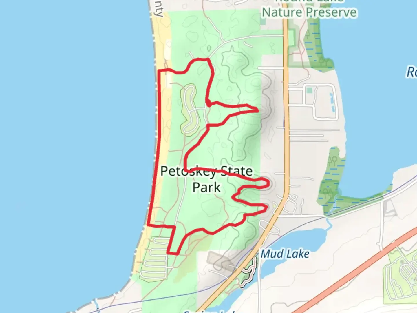 An image depicting the trail Old Baldy Trail and Petoskey State Park and its surrounding area.