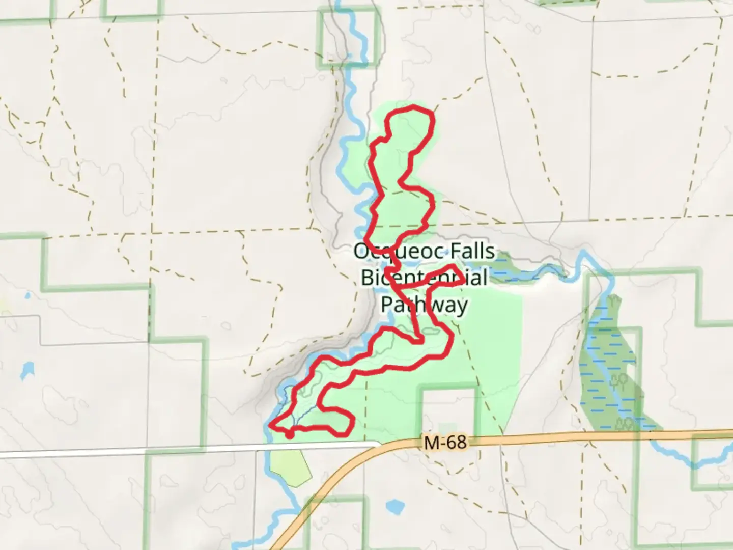 An image depicting the trail Ocqueoc Falls Bicentennial Pathway Loop and its surrounding area.